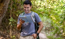 A man happy looking at the maps for his best trekking sites in nepal